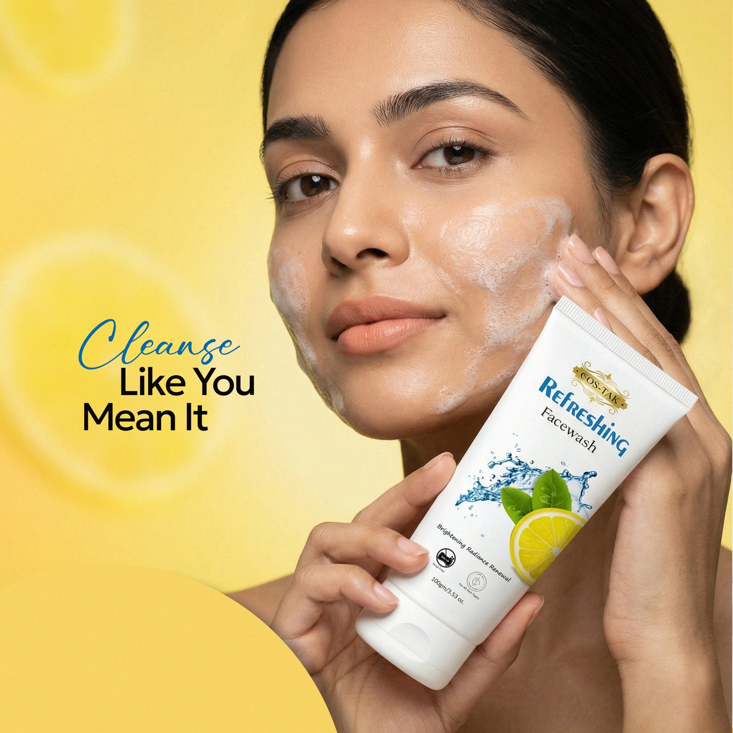 Costak Woman applying face wash to her face with a yellow background and text 'Cleanse Like You Mean It'.