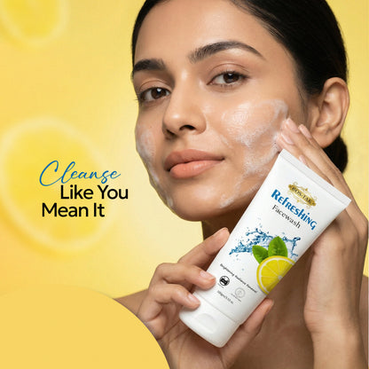 Costak Woman applying face wash to her face with a yellow background and text 'Cleanse Like You Mean It'.