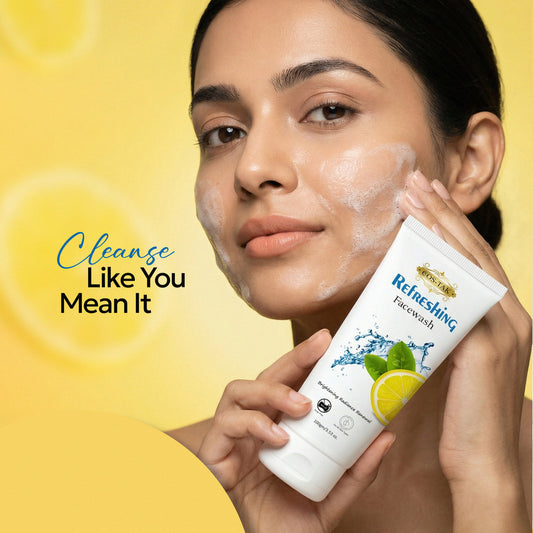 Costak Woman applying face wash to her face with a yellow background and text 'Cleanse Like You Mean It'.