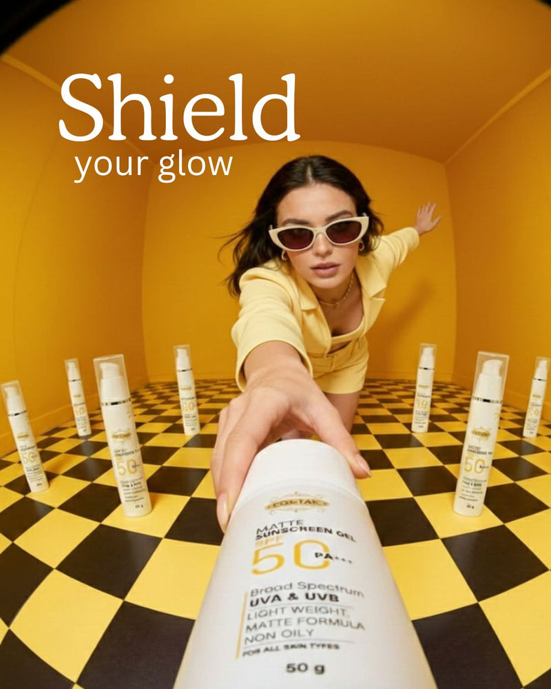 Costak Person holding a sunscreen bottle with 'Shield your glow' text and sunscreens on a checkered floor.